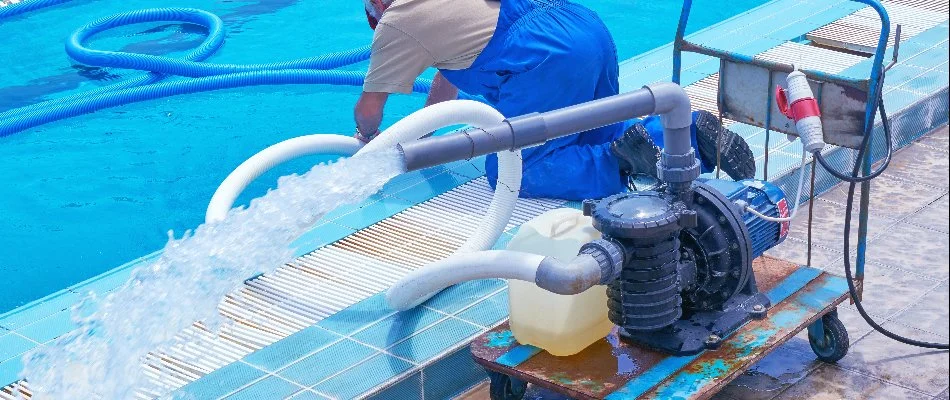 Worker in Bridgehampton, NY, inspecting a pool.