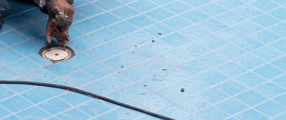 Pool tech repairing a leak in a pool.