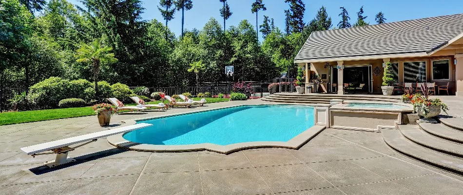 Pool with diving board on a property in North Haven, NY.