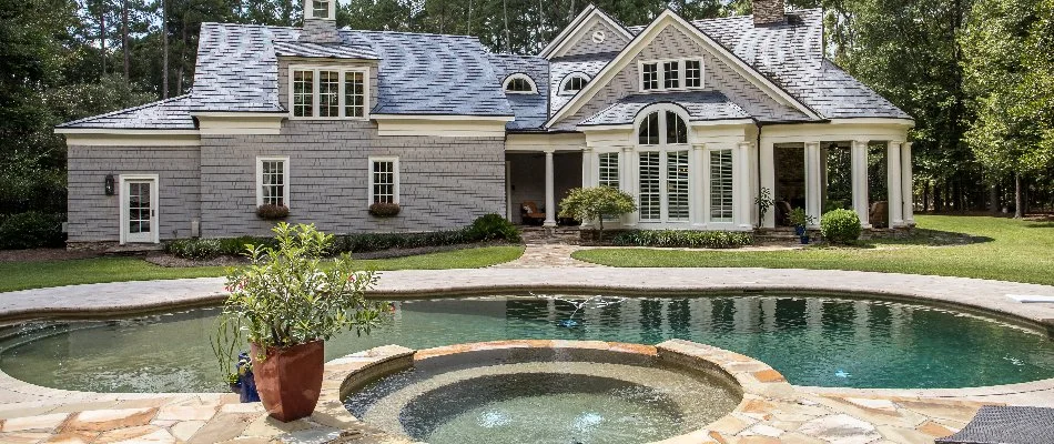 Swimming pool with hot tub on a residential property.