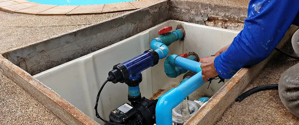 A technician maintaining pool pumps in Bridgehampton, NY.