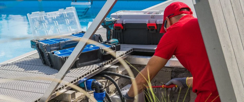 A worker in Bridgehampton, NY, repairing a pool.